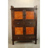 A contemporary Japanese inspired elm cabinet, with two cupboard doors enclosing a shelf over two