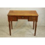 A 19th century mahogany kneehole writing table, the rectangular top with a moulded edge over three