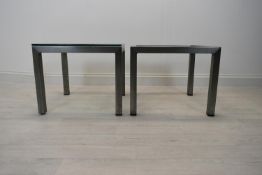 A pair of square brushed metal framed coffee side tables with glass top. Some chips to glass and one
