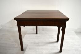 A George III mahogany rectangular fold over table raised on square supports. H.75.5 W.92.5 D.45.