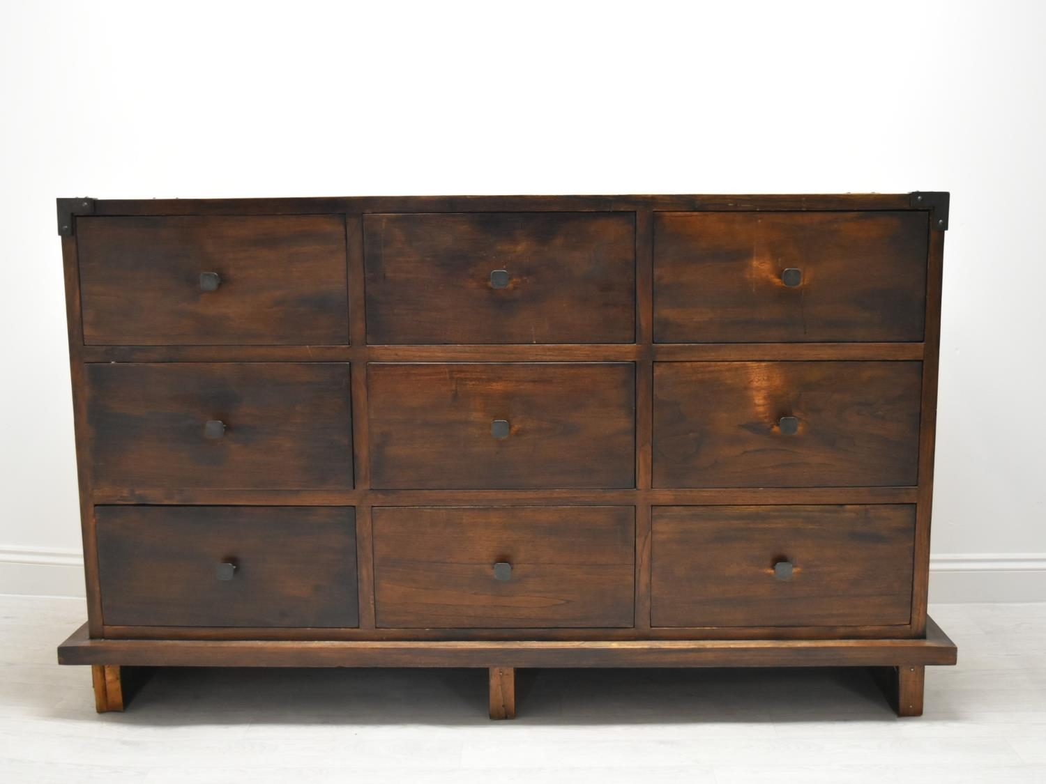 A contemporary Eastern hardwood sideboard with nine drawers raised on short supports. H.100 W.160.