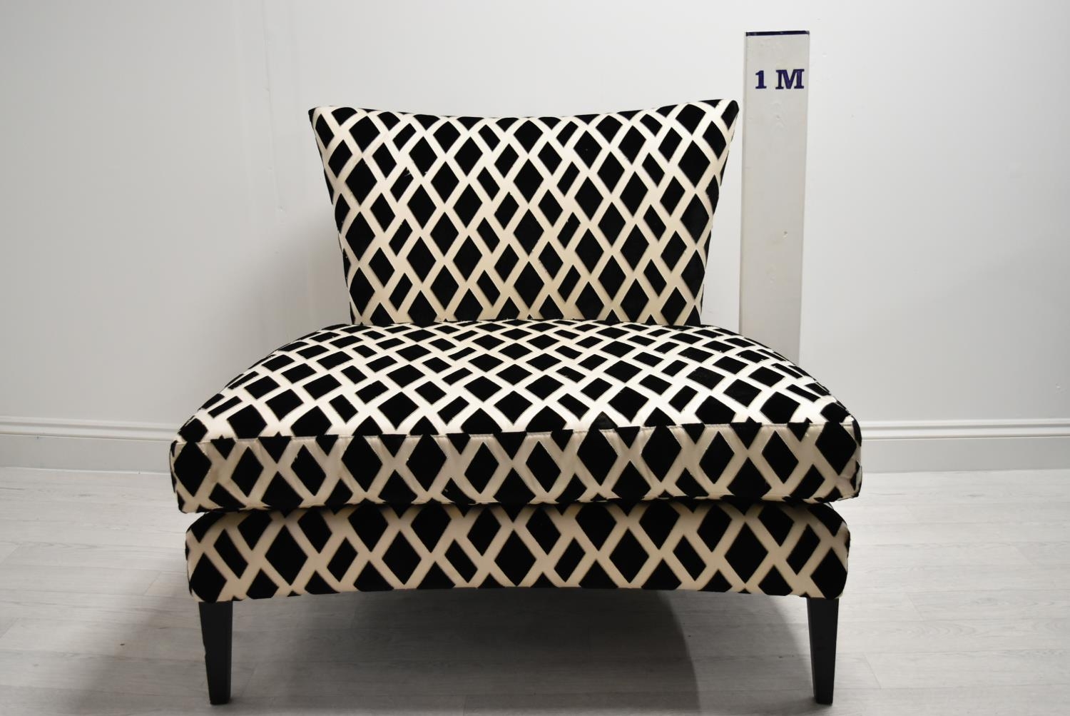 A contemporary black and white designer chair with loose cushions raised on tapering supports. H. - Image 2 of 5