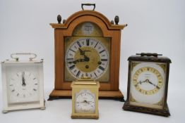 Four 20th century mantle clocks comprising Swiss brushed brass manfle clocks raised on ball feet,