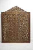 A mid 20th century two piece Indonesian teak carved hanging screen. H.149 W.117cm