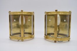 A pair of brass mounted and glass demi lune wall hanging lights with glass panels, electrified. H.19