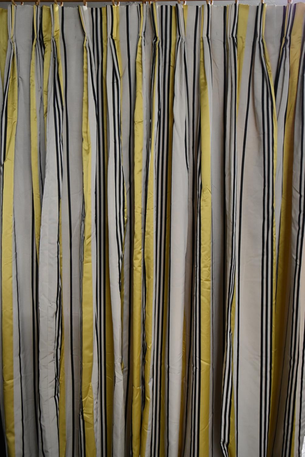 A pair of striped yellow, black and white lined curtains with tiebacks, weighted. H.340 W.92cm