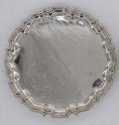 A George V hallmarked silver salver, Tessiers, London 1929, with pie crust rim and raised on