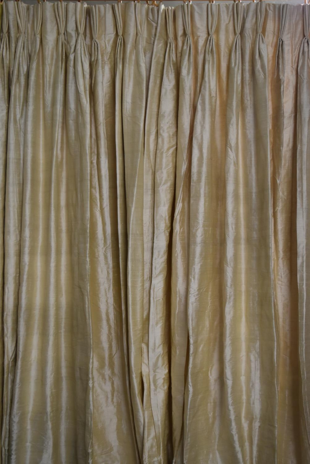 A pair of yellow silk interlined pinch pleated curtains. H.328 W.105cm