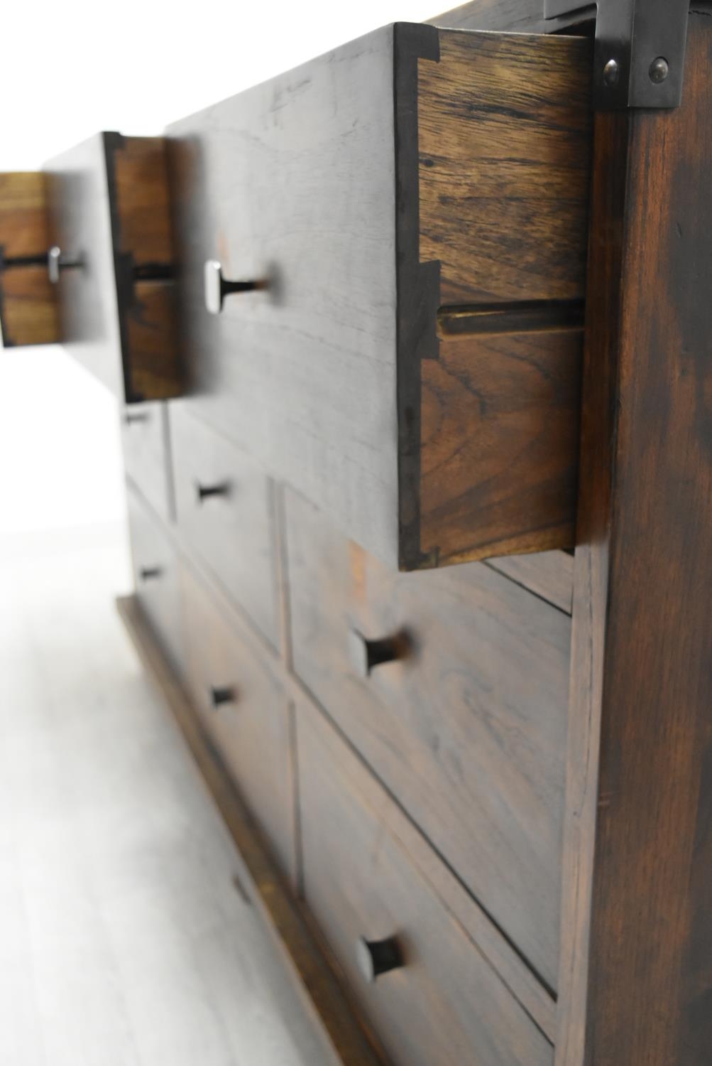 A contemporary Eastern hardwood sideboard with nine drawers raised on short supports. H.100 W.160. - Image 9 of 11