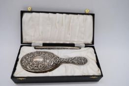 A cased Elizabeth II hallmarked silver backed dressing brush and comb by Broadway of Birmingham,