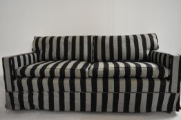 A contemporary two seater sofa upholstered in grey and black fabric. H.74 W.169 D.86cm