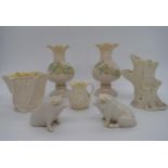 Seven pieces of Northern Irish Belleek porcelain to include a pair of vases, a pair of seated