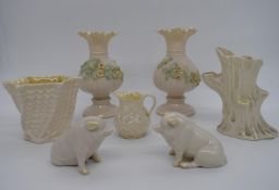 Seven pieces of Northern Irish Belleek porcelain to include a pair of vases, a pair of seated