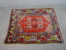 A red ground hand made Turkish Anatolian rug. W.160 D.130cm