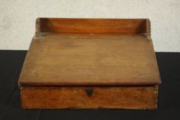 A 19th century pine writing slope with a gallery back and rising lid. H.20 W.43 D.40cm.