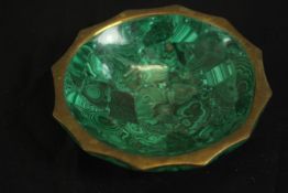 A 20th century malachite bowl with a bronze scalloped edge. H.2.5 Dia.11cm.