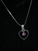 A 18 carat white gold openwork heart pendant and snake chain. The pendant set with a round mixed cut