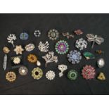 A collection of twenty eight vintage and contemporary paste brooches of various designs, including
