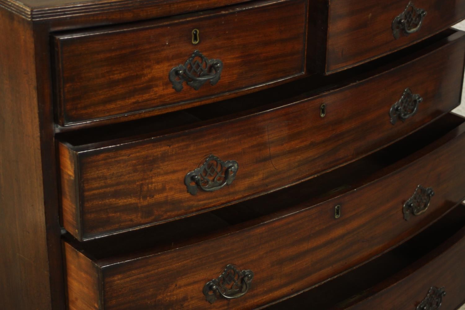 A George III bowfronted mahogany chest of two short over three long drawers above a shaped apron and - Image 6 of 8