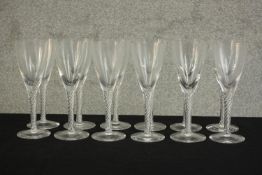 A set of twelve clear glass air twist stem champagne glasses. H.17 Dia.7cm. (largest)