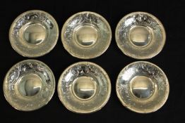 A collection of six Austrian engraved foliate and floral design silver saucers by Vincenz Carl