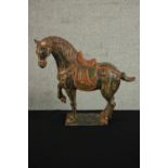 A Chinese Tang style painted ceramic horse on rectangular base. (Broken ear.) H.39 W.43 D.14cm.