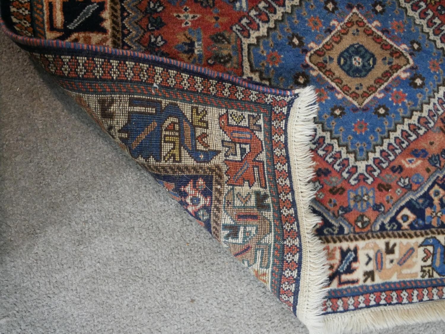A rust ground hand made Persian Yalameh rug. W.126 D.86cm - Image 3 of 3