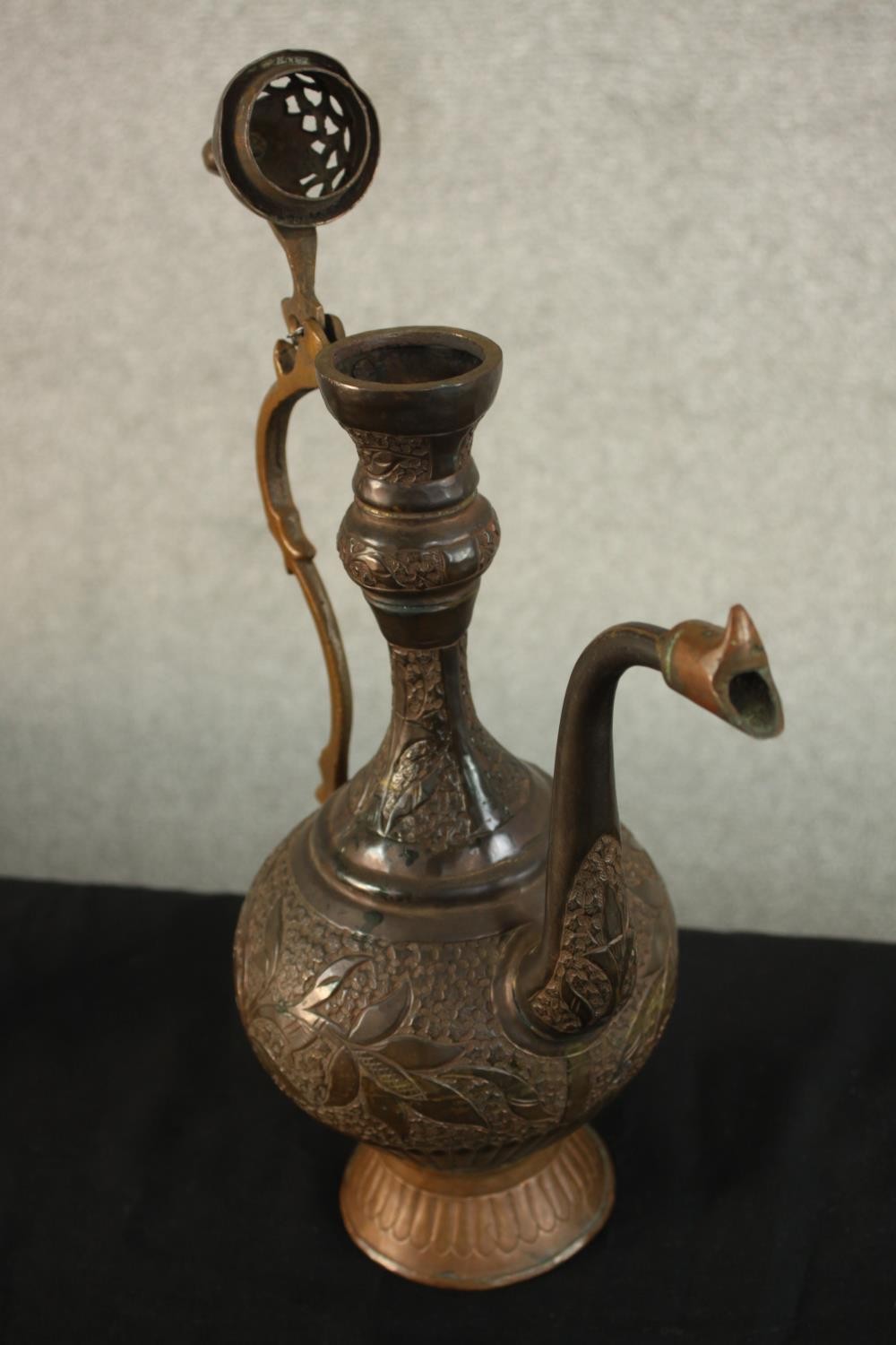 A Turkish engraved copper ewer decorated with a foliate design. H.37 W.24 D.13cm. - Image 8 of 12