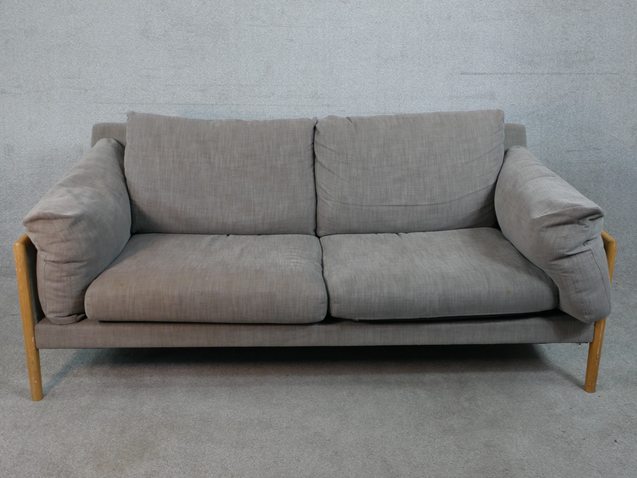 A John Lewis two seater sofa, upholstered in grey fabric, with oak arms and legs. H.77 W.192 D.88cm