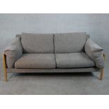 A John Lewis two seater sofa, upholstered in grey fabric, with oak arms and legs. H.77 W.192 D.88cm