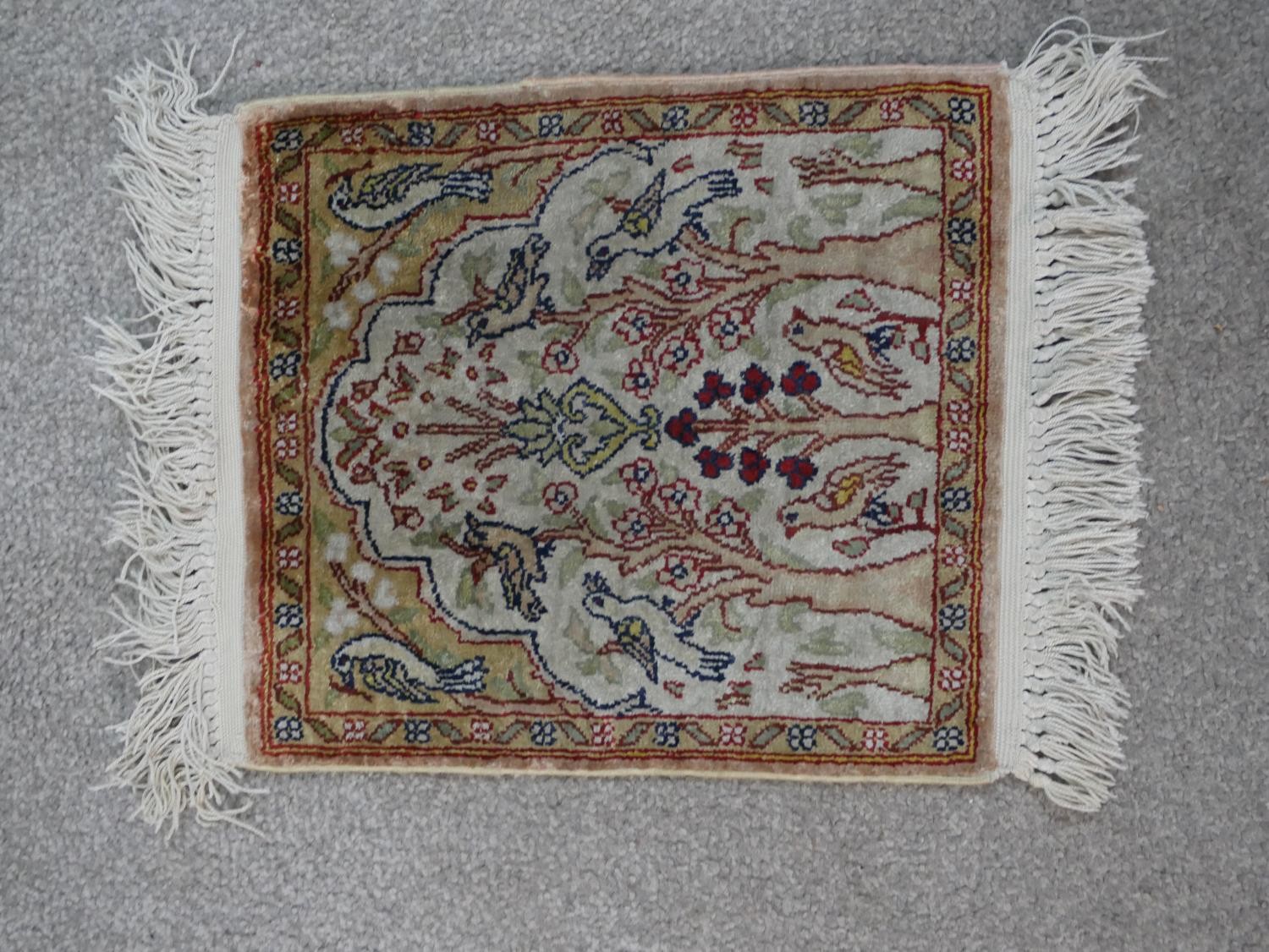 A cream ground hand made Persian silk Kum rug. W.33 D.28cm