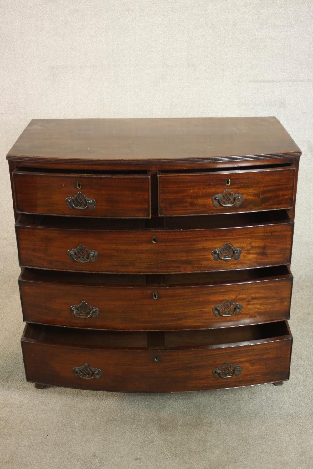 A George III bowfronted mahogany chest of two short over three long drawers above a shaped apron and - Image 3 of 8