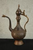 A Turkish engraved copper ewer decorated with a foliate design. H.37 W.24 D.13cm.