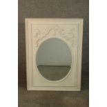 A 19th century style white painted mirror, the oval mirrored plate in a rectangular frame with