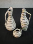 Three mid-century black and yellow abstract linear design handled vases, impressed numbers to