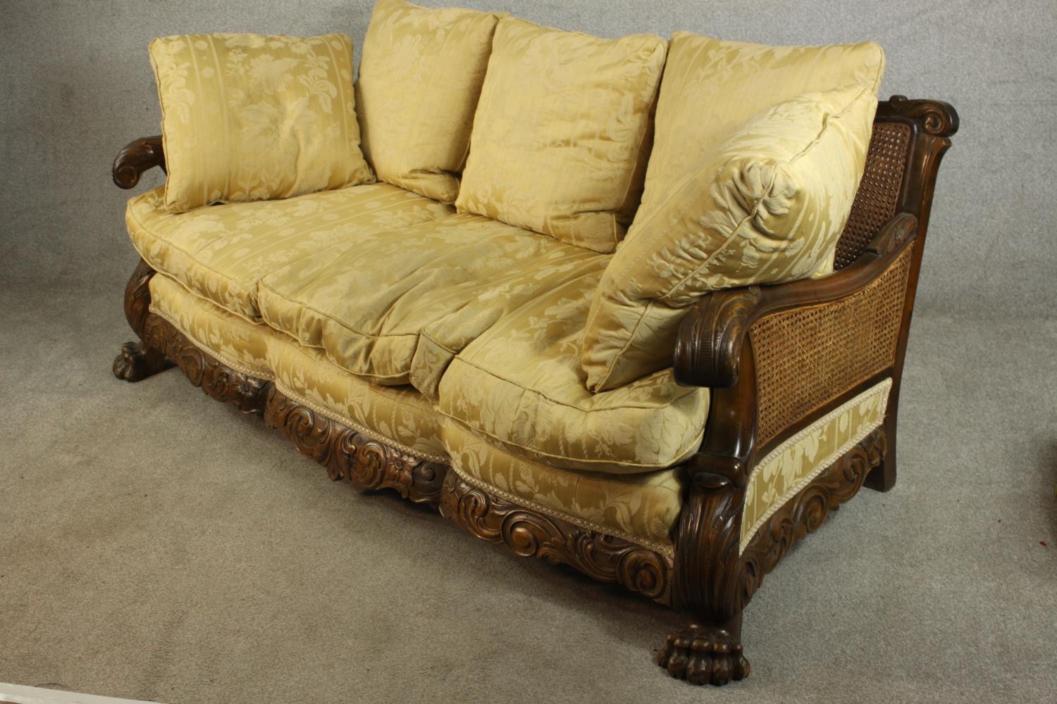 An early 20th century Continental carved walnut three seater bergere sofa, upholstered in gold - Image 4 of 18