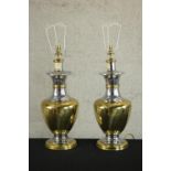 A pair of mid 20th century brass and chrome table lamps, of baluster form with circular feet. H.76