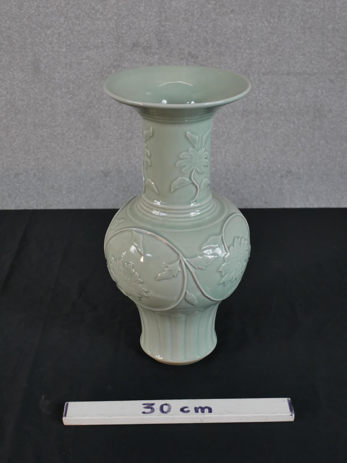 A Chinese celadon glazed porcelain vase, with a flared rim, a slender neck and a bulbous body, - Image 2 of 4