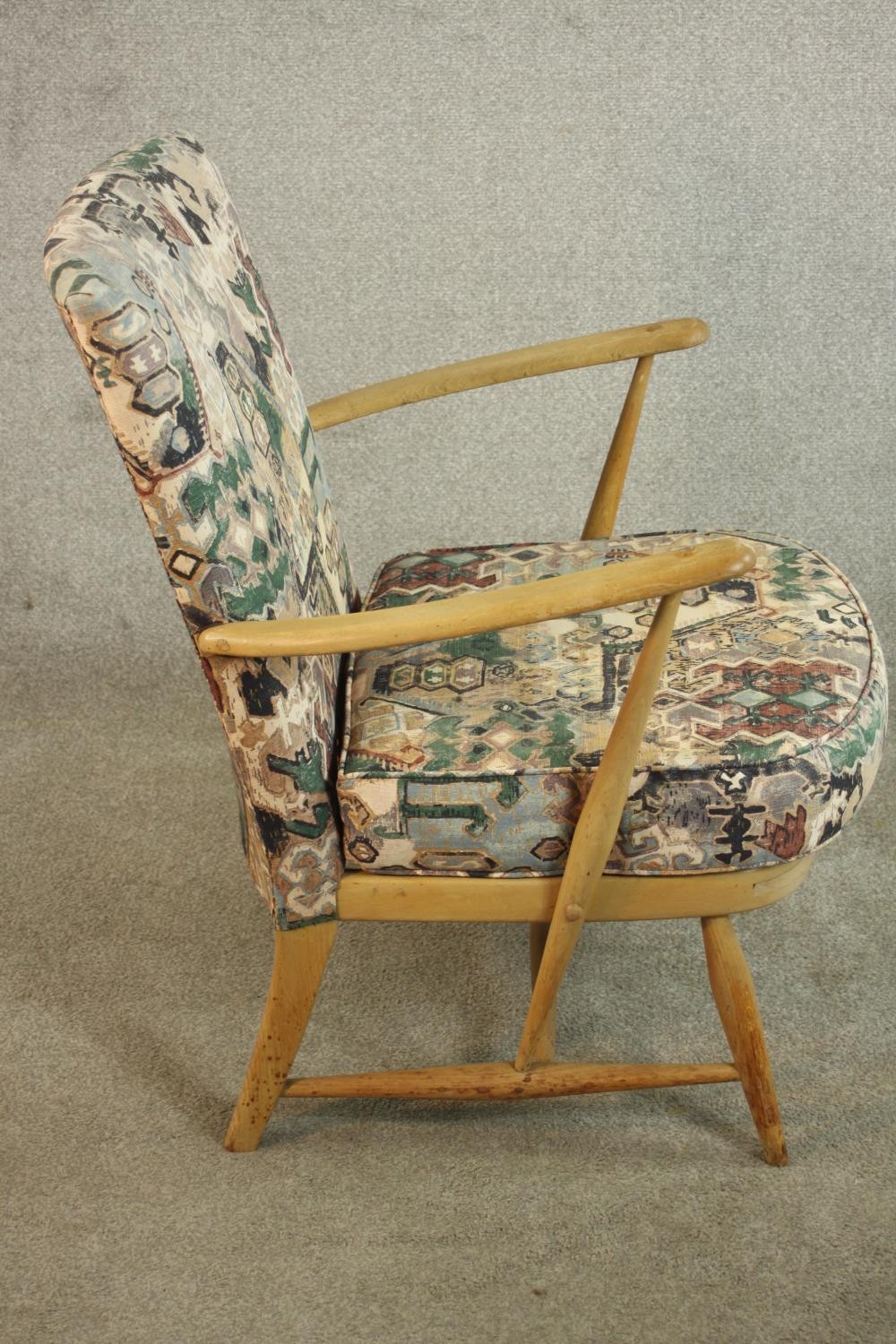 An Ercol beech armchair, with open arms, upholstered to the back and seat cushion. H.80 W.65 D.68cm. - Image 4 of 9