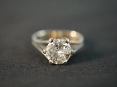 A red leather boxed 14 carat white gold diamond solitaire ring with an approximate carat weight of