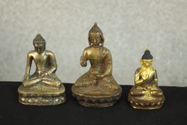 Three 20th century brass and bronze Indian Buddhas, one with gilded detailing. H.11 W.7 D.5cm. (