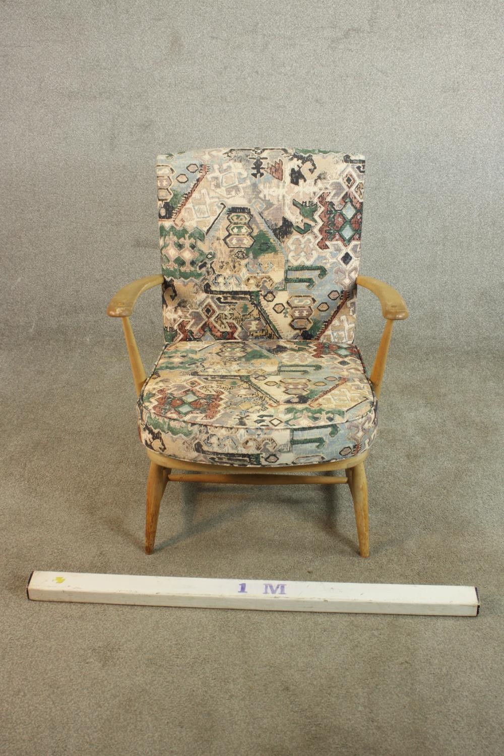 An Ercol beech armchair, with open arms, upholstered to the back and seat cushion. H.80 W.65 D.68cm. - Image 2 of 9