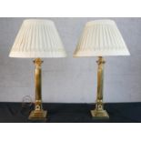 A pair of Classical brass fluted column table lamps with relief laurel wreath motifs on stepped