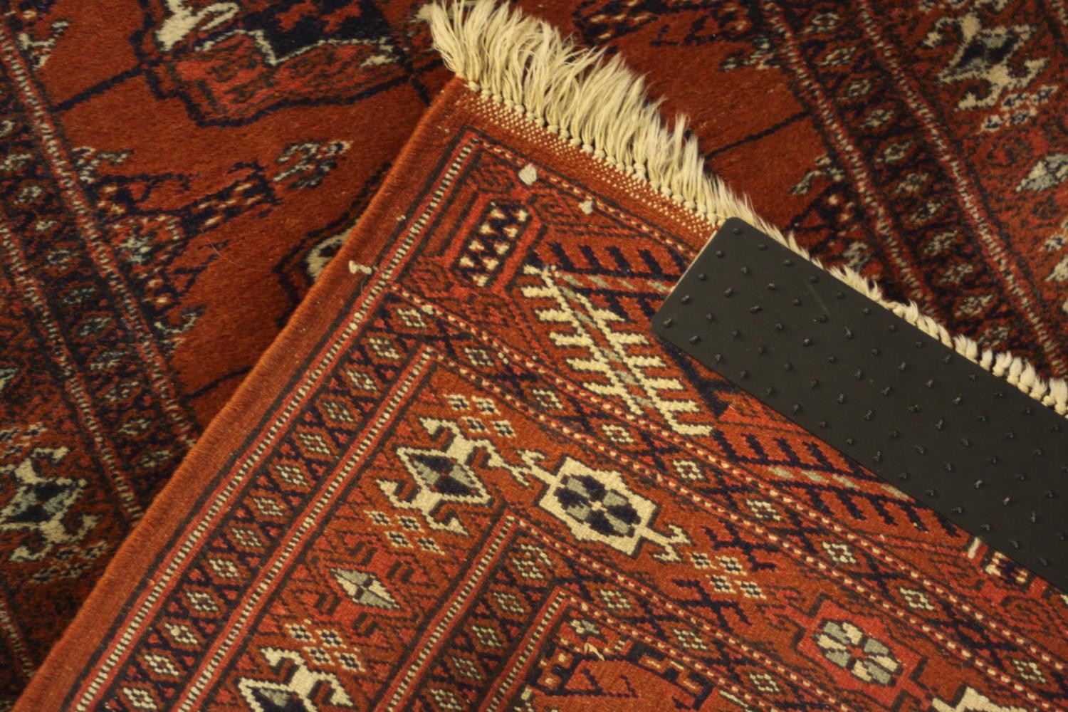 A hand made rust ground Bokara rug. L.92 W.54cm. - Image 4 of 4