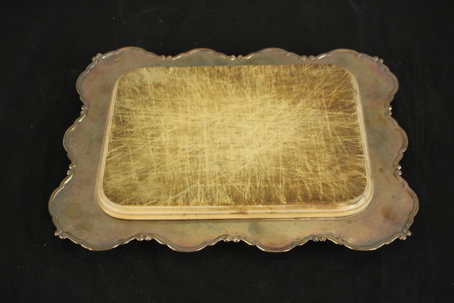 A Silver plate Chollah bread board with hardwood removable board. H.4 W.32 D.25cm.