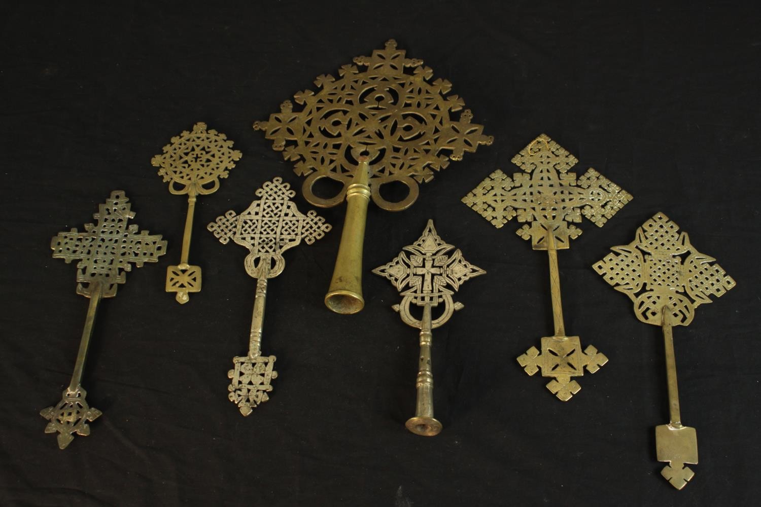 Seven Ethiopian Coptic brass and silver plated hand crosses, two with engraved detailing. H.36 W.