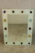 A contemporary rectangular mirror, the frame applied with coloured glass cabochons. H.80 W.60cm.