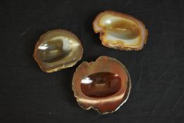 Three carved and polished banded agate slice ashtrays. H.2 L.12cm. (largest)