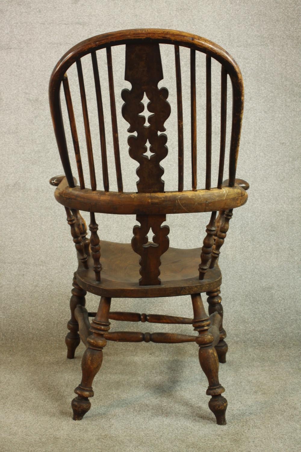 A 19th century Windsor armchair, with a yew hoop back and pierced splat over an elm seat, on - Image 6 of 7