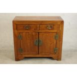 A 20th century Chinese elm side cabinet, with a single drawer over a pair of cupboard doors with